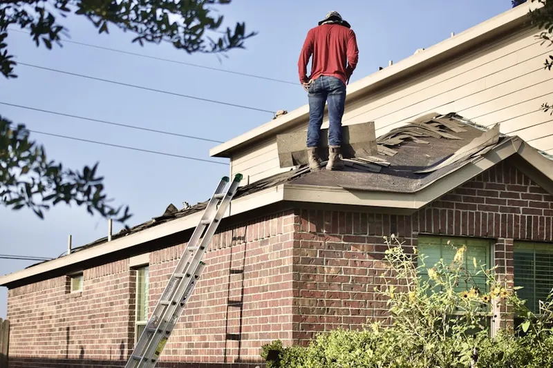 Professional roofer working on a residential roof in Marblehead
